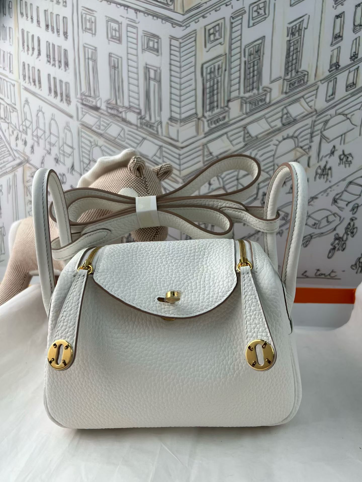 Cream White Togo Leather Mini Lindy, Fully Hand-Stitched Waxed Thread, Gold-Tone Solid Steel Hardware, Lambskin Lining, Extra Matching Leather Strap, Custom Embossing & Hot Stamping Available